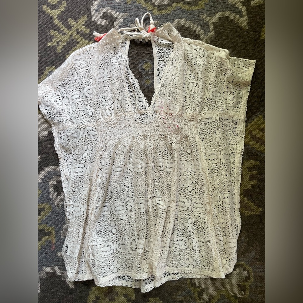 New with tags on lace cover-up. Cream color, tie in back, deep v front.